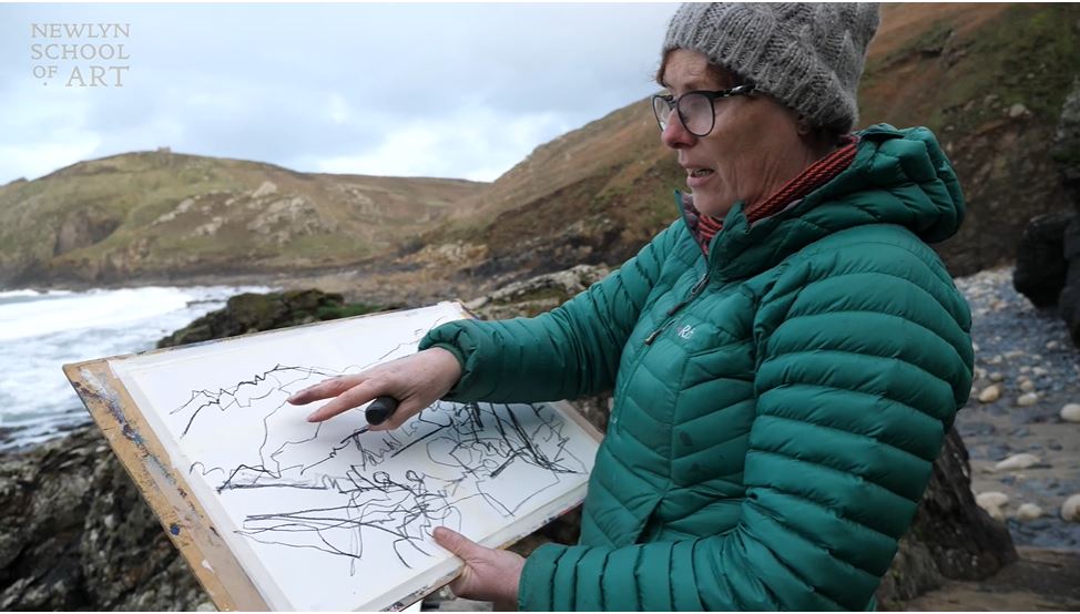 Anita Pointing to her artwork in the landscape